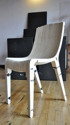 a white chair sitting on top of a hard wood floor