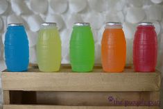 four plastic soda bottles lined up in a row