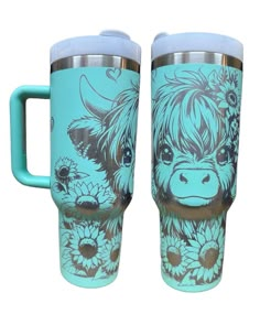 two travel mugs one with a cow and flowers painted on the side, both have handles