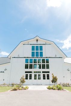 a large white barn with lots of windows