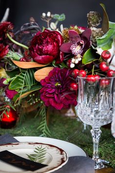 a close up of a plate with flowers on it near other plates and vases