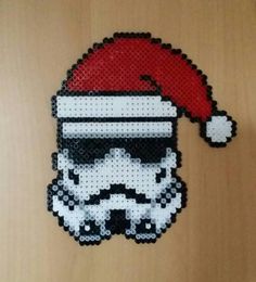 a star wars beaded ornament with a santa hat on it's head