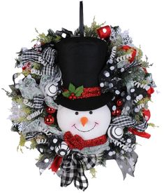 a christmas wreath with a snowman wearing a top hat