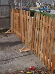 a wooden fence that is next to a street