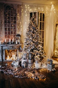 a decorated christmas tree sitting in front of a fireplace