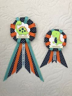 two ribbons with dinosaurs and polka dots on them