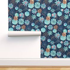 the wall paper is designed to look like hexagons and succulents