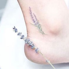 small lavender flower tattoo on the foot