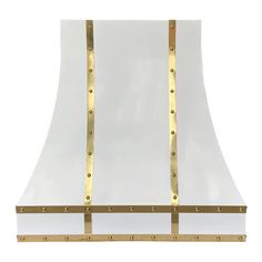 a white and gold stove hood with metal trimmings on the front, against a white background