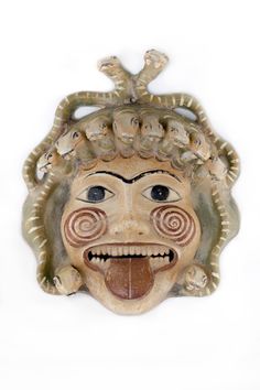 an old mask with many faces on it