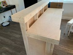 an unfinished desk is shown in the middle of a room