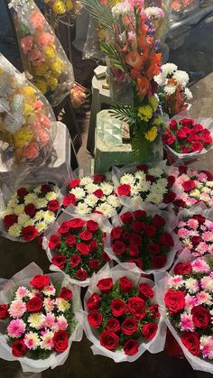 many different types of flowers on display for sale