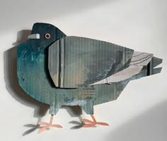 a bird made out of cardboard sitting on top of a table