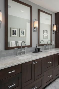 a bathroom with double sinks and two mirrors on the wall next to eachother