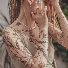 a woman with tattoos covering her face and hands