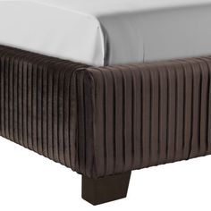 an upholstered bed with white sheets and brown wood legs, on a white background