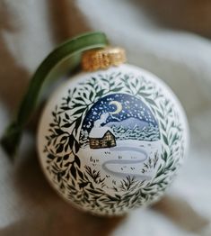 a christmas ornament with a painting on it