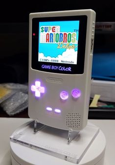 an old nintendo game boy color sitting on top of a table