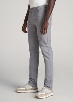 About Our Men's Tall Pants Straightforward tall pants for men, designed to be worn every day. With sizes tailored specifically for tall men between 6'3” and 7'1”, our Dylan pants have extended rises, bigger pockets, adjusted knee placement, and a longer length. These tall slim-fit pants for tall men have an extra-long inseam of up to 40” and will hug your hips and thigh to compliment your physique. Made with both cotton and spandex, they are designed to let you move freely throughout your workda Gray Slim Fit Dress Pants With Tapered Leg, Classic Gray Slim Fit Bottoms, Bigger Pockets, Gray Comfort Stretch Full-length Pants, Gray Slim Fit Ankle-length Pants, Cheap Full-length Men's Dress Pants, Smart Casual Style, Tall Men, Tall Pants