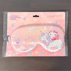 the hello kitty sleep mask is packaged in a pink package with unicorns on it