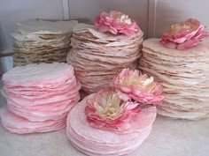 several stacks of pink and white paper with flowers on them