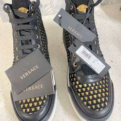 Selling Black & Gold Versace Sneakers Size: 13.5 Message For Serious Inquiries Only Price Negotiable Versace Loafers, Black And Gold Sneakers, Versace Chain, Brown Leather Sneakers, Shoes Men Sneakers, Versace Sneakers, Versace Shoes, Gold Sneakers, Black And White Sneakers