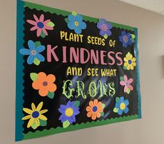 a sign that says plant seeds of kindness and see what grows on the wall