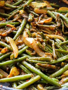 cooked green beans and onions in a pan