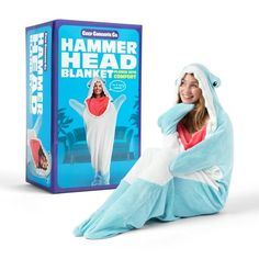 a woman in a costume sitting next to a cardboard box and wearing a shark costume