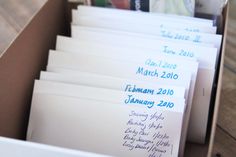 a box filled with lots of white envelopes and writing on the inside of it