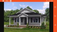 a small gray house sitting on top of a lush green field