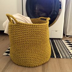 a laundry basket next to a washing machine