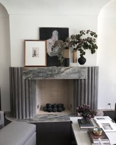 a living room filled with furniture and a fire place in front of a painting on the wall