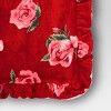 a red bag with pink roses on it