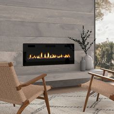 a living room with a fireplace and two chairs in front of the fire place that has a flat screen tv above it