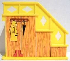 a yellow dollhouse with a coat and umbrella