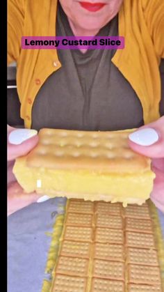 a woman is holding up a lemon custard slice