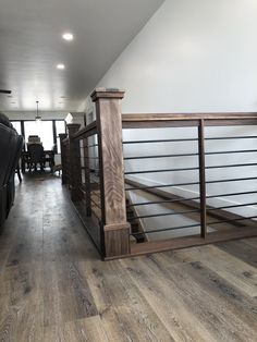 a truck is parked in a garage with wood floors and railings on the sides