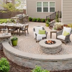 a fire pit surrounded by chairs and tables