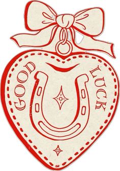 a red and white heart shaped ornament with the word good luck on it