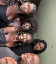 four women are standing together and smiling for the camera