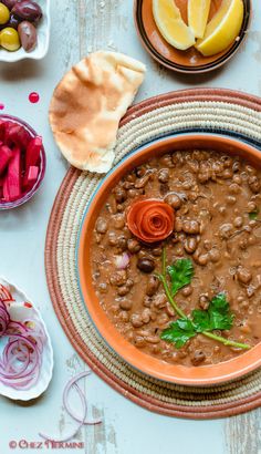 a bowl filled with beans and vegetables next to other foods