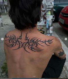 a man with a tattoo on his back