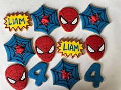 decorated cookies with spiderman faces and name written on them