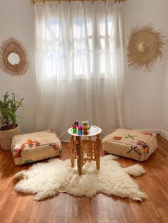 a living room filled with furniture and a rug on the floor next to a window