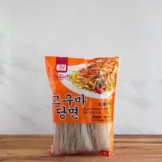 a bag of noodles sitting on top of a wooden table