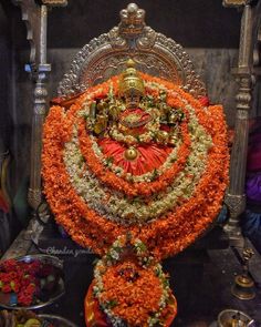 an elaborate display of flowers and decorations in a temple