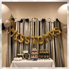 a table topped with balloons and desserts