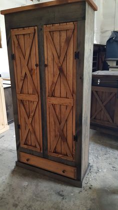 a large wooden cabinet sitting inside of a kitchen