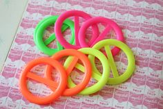 four different colored plastic rings sitting on top of a table